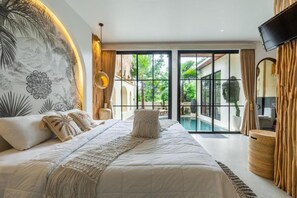 A bedroom with a large bed, a view of a swimming pool, and a TV mounted on the wall. - Maha Villa Ubud (Sukawati)