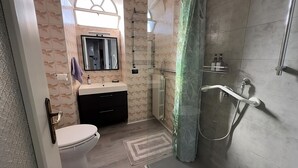 A modern bathroom with a toilet, sink, mirror, shower, and a glass-enclosed shower stall. - The house on the harbor, Major: central, partial lake view, parchegggio (Mombello)