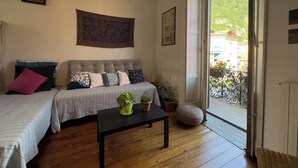 A cozy living room with a sofa, a coffee table with plants, and a view of a balcony with a railing. - The house on the harbor, Major: central, partial lake view, parchegggio (Mombello)