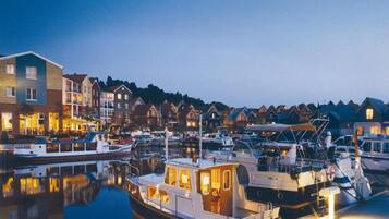 A marina with boats docked, surrounded by residential buildings.
