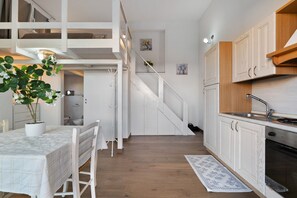 A modern kitchen with wooden cabinets, a built-in oven, and a sink. - Apartment 'Casa Del Mirto' with Private Terrace, Wi-Fi and Air Conditioning (Olbia)