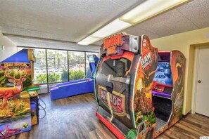 A room with arcade games including 'Jurassic Park' and 'Raw Thrills'. - Cozy 1-bedroom condo in tranquil Myrtle Beach (Myrtle Beach)