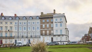 A row of terraced houses with a building labeled "The Langley" in the foreground. - Host & Stay | The Langley Hotel, Apartment 8 (Whitby)