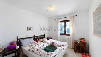 Tabla de planchar con plancha y ropa de cama