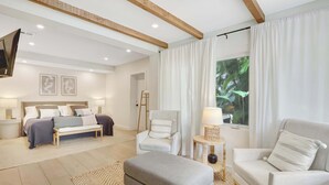 A modern hotel room with a bed, two armchairs, a sofa, a small table, and a large window with curtains. - Casa in Tropic Paradise with Pool and BBQ (Biscayne Park)