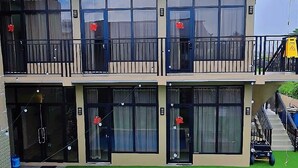 A hotel with a pool, outdoor seating, and balconies. - Jagdesh Apartments  (Anna Regina)