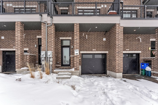 Exterior view of the modern brick townhouse and private garage