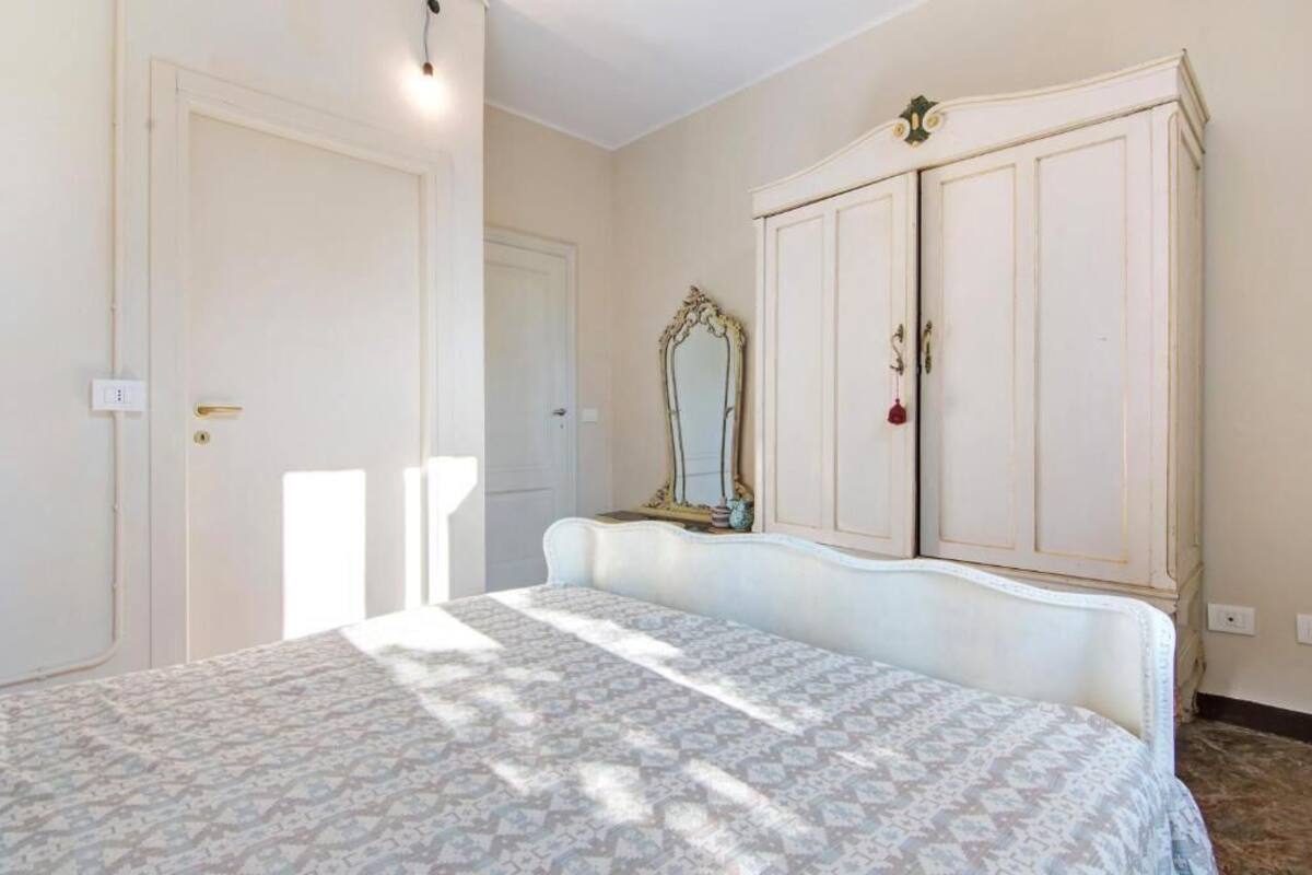 Un dormitorio con una cama, un armario y un espejo.