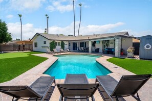 Outdoor pool, a heated pool - Desert Oasis 4-bedroom house w/ pool near shopping, Spring Training & more! (Glendale)