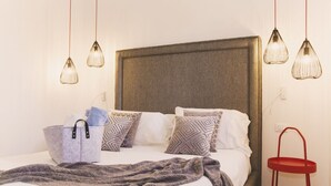 A bed with patterned pillows, a grey blanket, and a grey storage basket. - Villa delle Sterlizie by LeDhome (Balestrate)