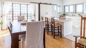 A spacious kitchen with a large island, wooden flooring, and a high ceiling with exposed beams. - My Sandlot Parguera- Beach Chalet up to 16 guests (La Parguera)