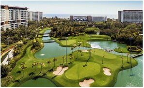 A golf course with bunkers, water hazards, and palm trees. - One Bedroom Suite Grand Mayan, Vidanta's Luxury Beach Resort, VIP Theme Park acc (Nuevo Vallarta)