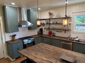 A modern kitchen with grey cabinets, a wooden countertop, and a central island. - Historic Craftsman Home (Moscow)