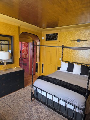 A bedroom with a four-poster bed, a dresser, and a mirror. - Uniquely Charming "Downeastah" APT in the heart of Machias (Machias)
