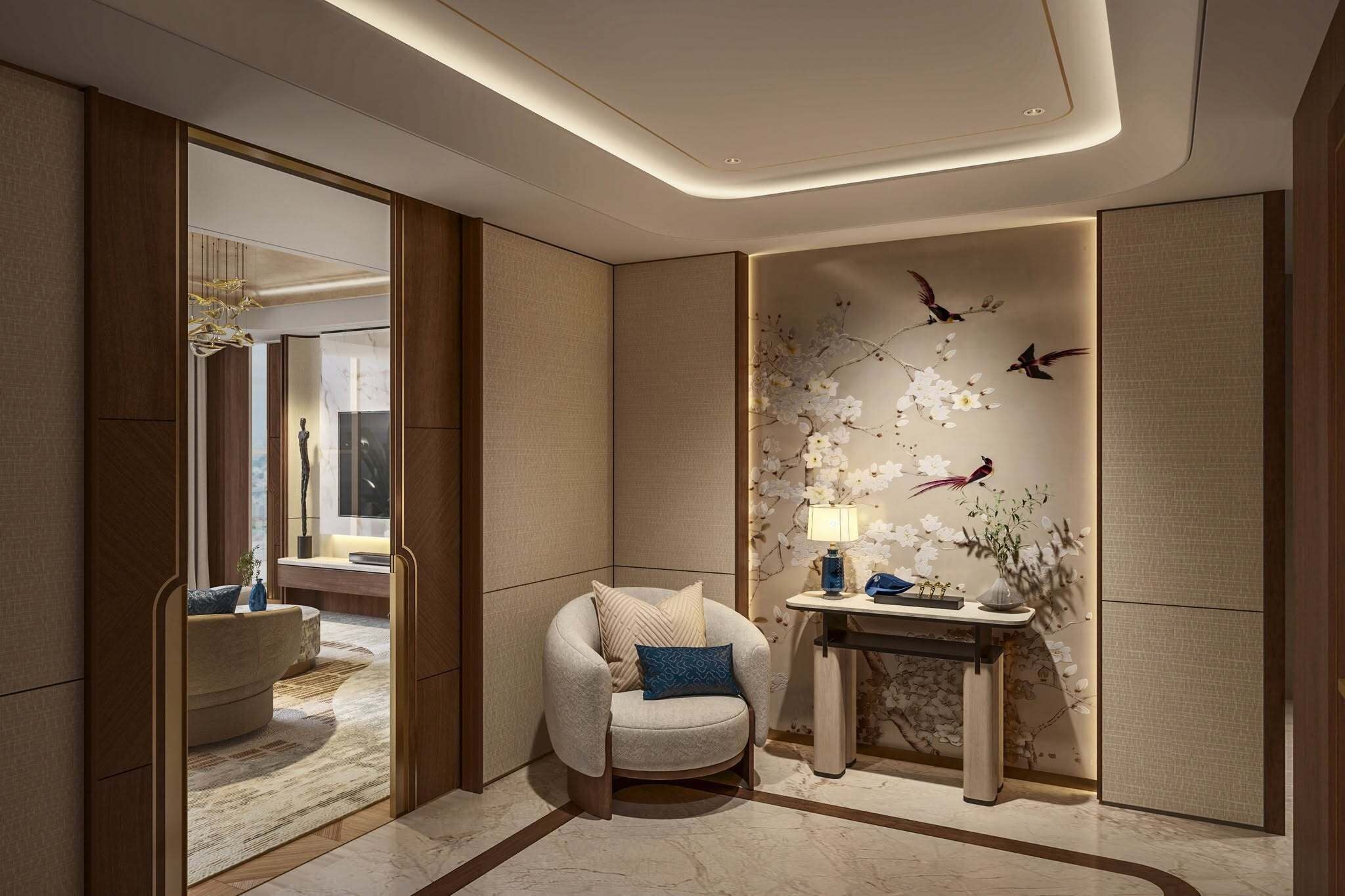 A modern interior with a round chair, a small table with a lamp, and a decorative wall with floral and bird motifs.