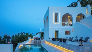 A modern building with a pool, outdoor seating, and a staircase leading to the upper levels. - Villa Eterea - Five Bedroom Villa, Sleeps 10 (Selva di Fasano)