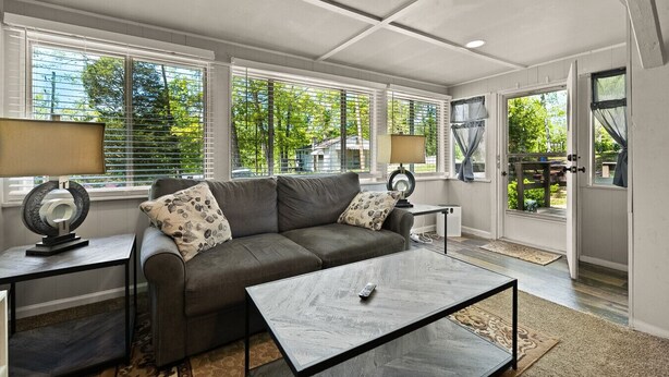A modern living room with a sofa, coffee table, and lamps.