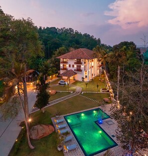 A two-story house with a swimming pool, surrounded by lush greenery and palm trees. - Luck Nature Villas Habaraduwa Galle (Habaraduwa)