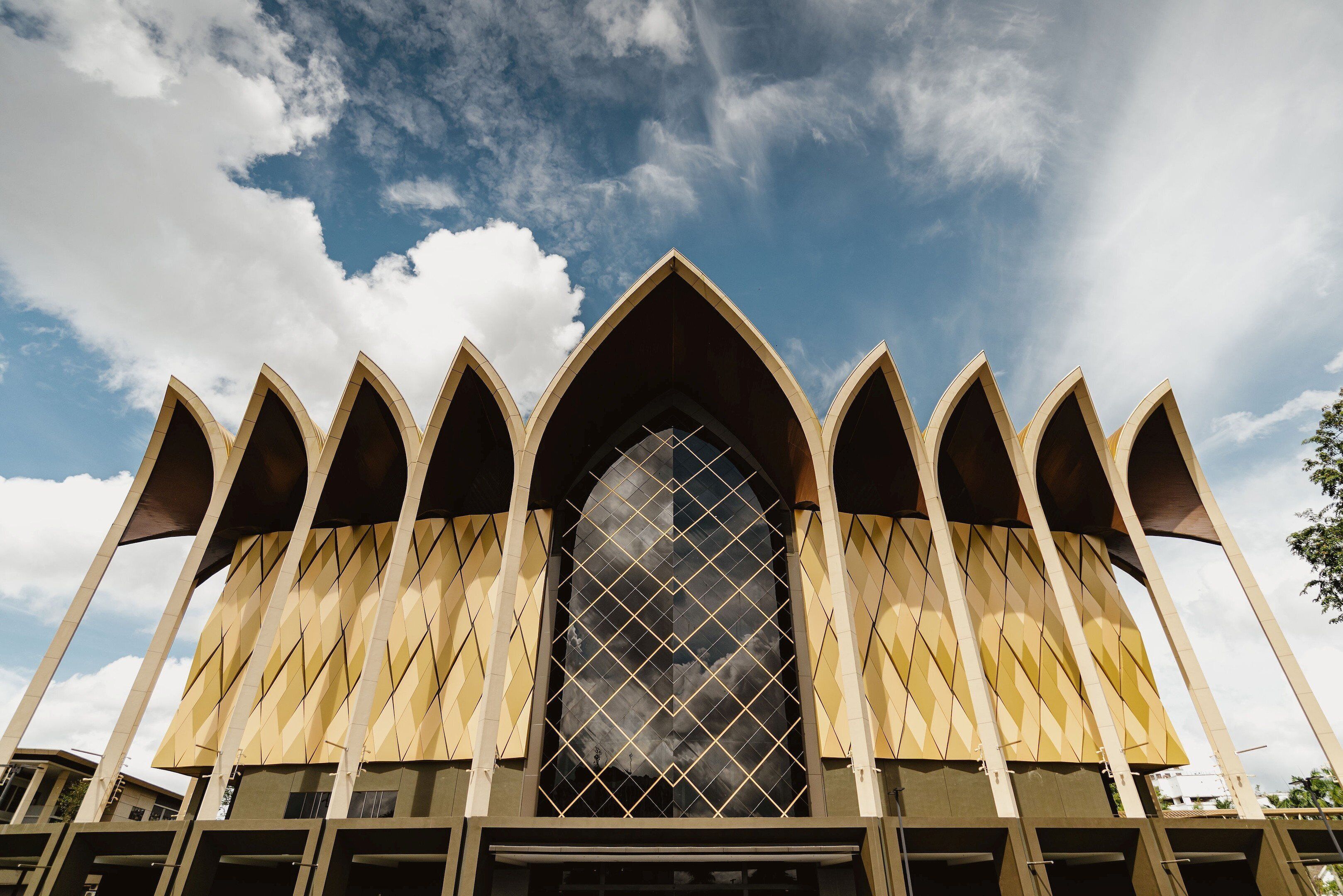 A building with a large arched window and multiple pointed arches.
