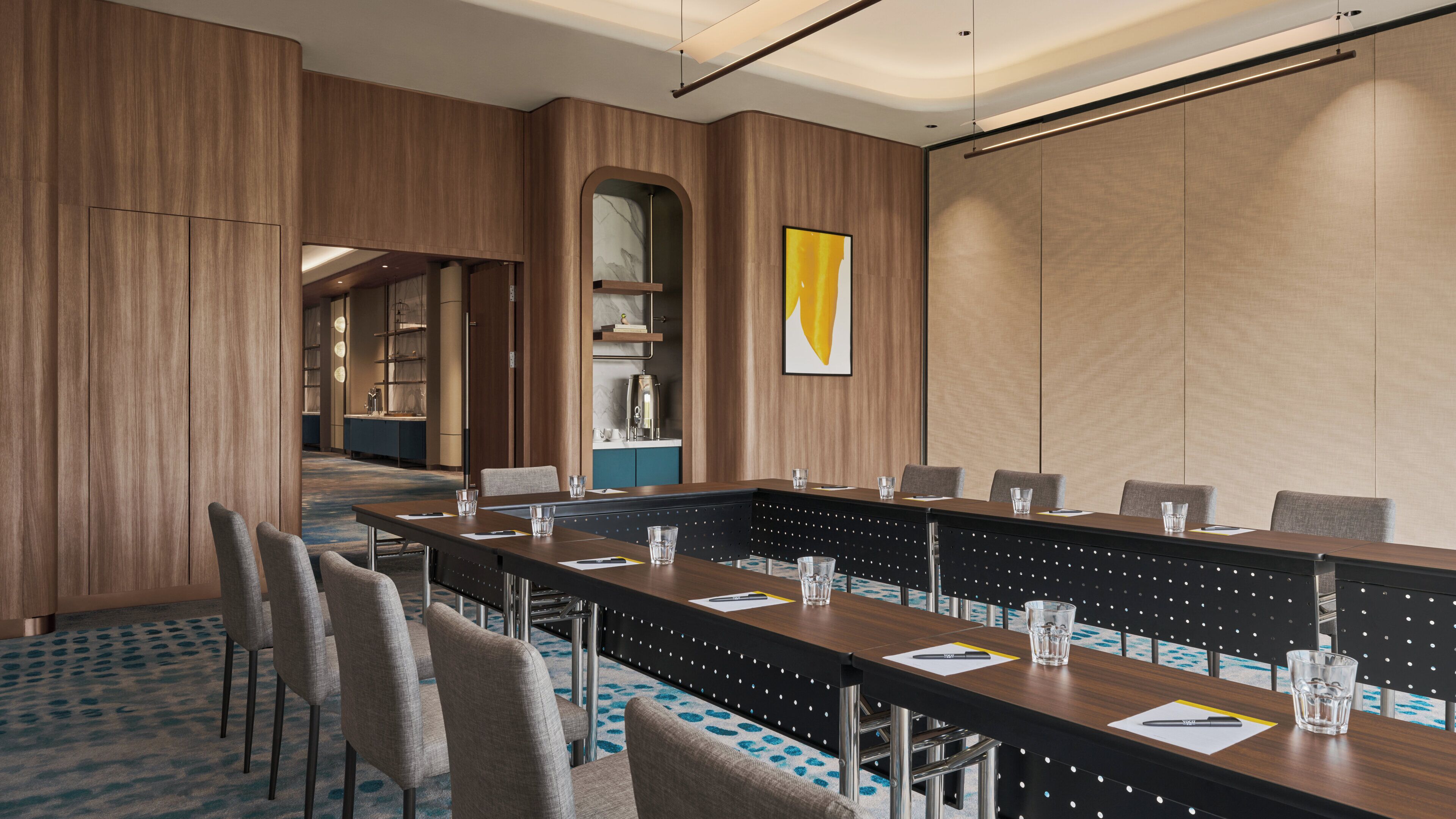A conference room with a long table, chairs, and a modern interior design.