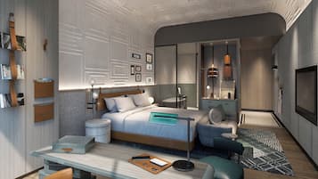 A modern bedroom with a bed, bedside tables, a desk, and a seating area.