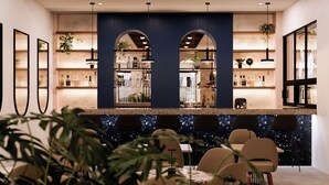 A modern bar area with a central counter, seating, and shelves with bottles. - Holiday Inn Puerto Plata-Cofresi Bay Area By Ihg (Puerto Plata)