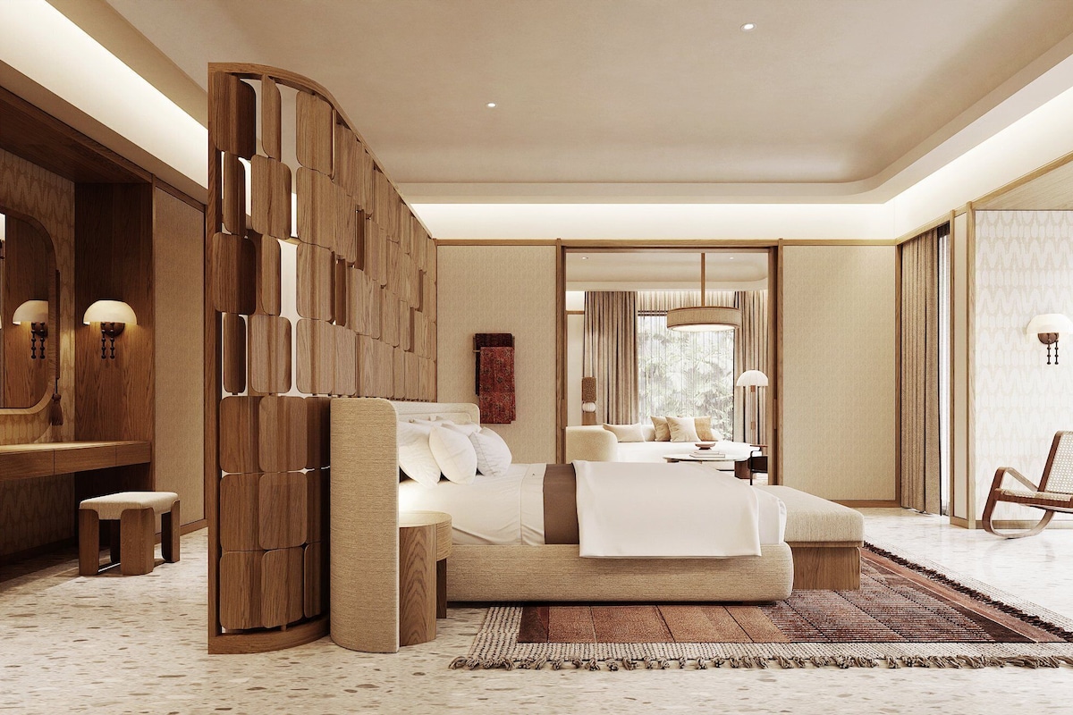A spacious bedroom with a large bed, wooden paneling, and a view of a balcony.