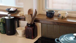 A kitchen counter with various utensils, a coffee maker, a mug, and a pot. - Cozy and private one-bedroom studio in Bishop (Bishop)