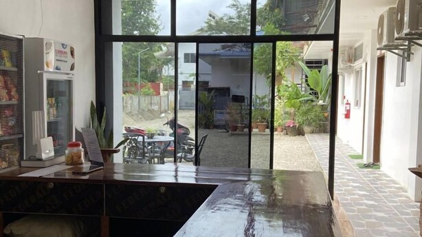 A kitchen with a large window, a refrigerator, and a counter. - Cozy Stay at Jezette’s Inn (Barangay 5, Sipalay City)