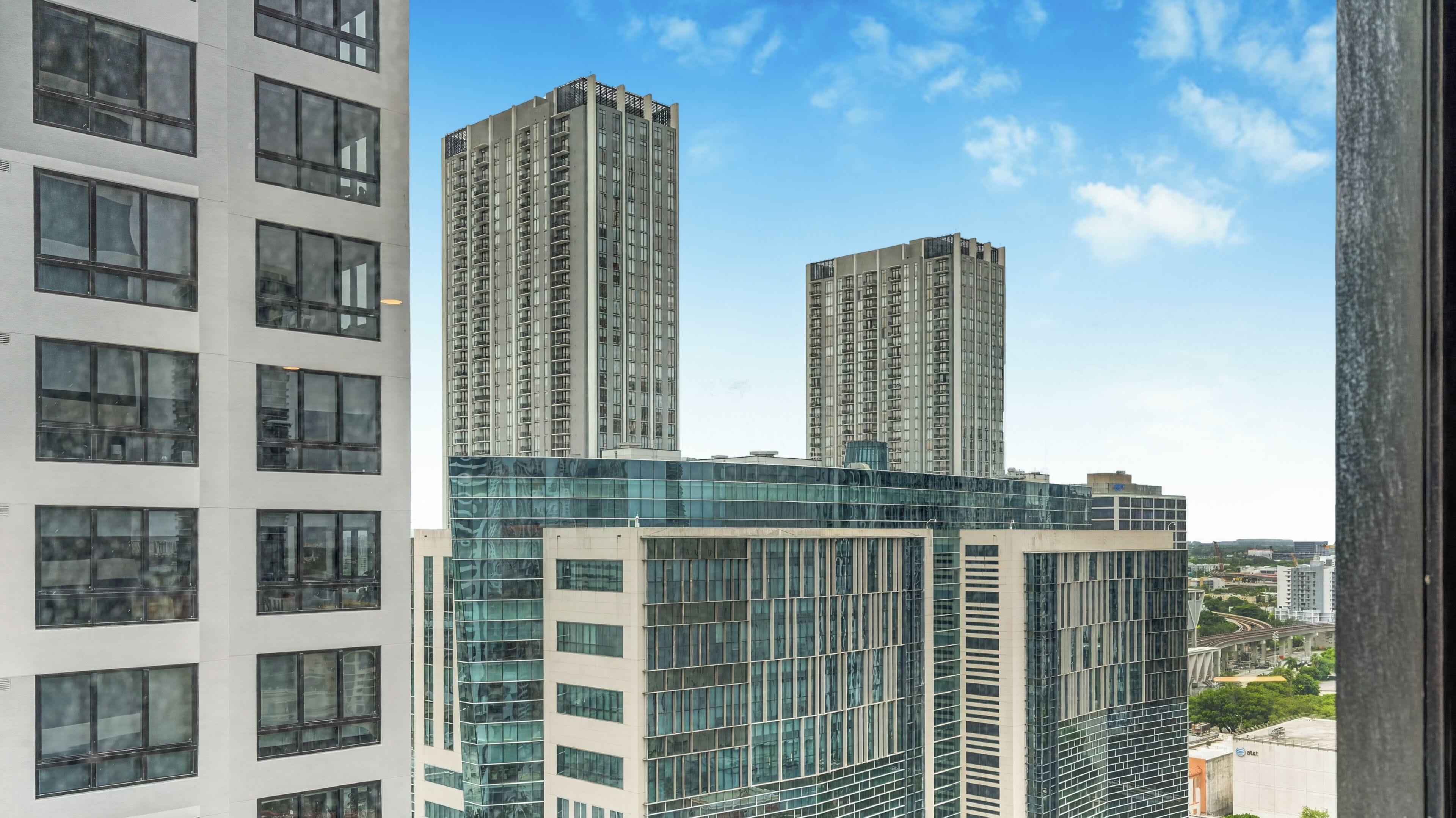A modern high-rise building with multiple floors, large windows, and a glass facade.
