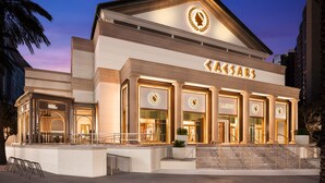 A large, multi-story building with a prominent casino sign, a grand entrance with steps, and a well-lit facade. - Caesars New Orleans Hotel & Casino - A Caesars Rewards Destination (New Orleans)