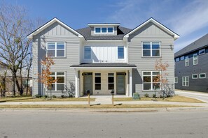 A two-story residential building with a gabled roof, a front porch, and a garage door. - < 1 Mi to Texas A&M: Group Getaway w/ Balcony! (College Station)