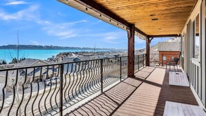 A wooden deck with a curved railing overlooking a coastal landscape. - Comfort, Convenience, and Room for the Whole Crew (Garden City)