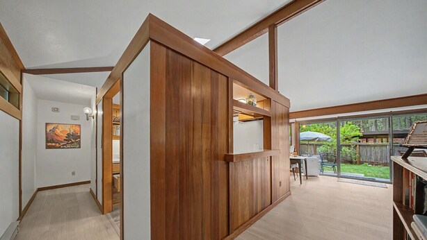 A room with wooden paneling, a sliding door, a dining area with outdoor seating, and a view of the backyard. - Pet friendly, fully fenced, A/C (Graeagle)