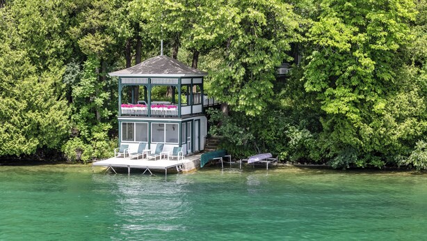 A multi-level dock with a gazebo, lounge chairs, and a covered seating area. - Villa von Baumbach - Trade Screens for Stories (Elkhart Lake)