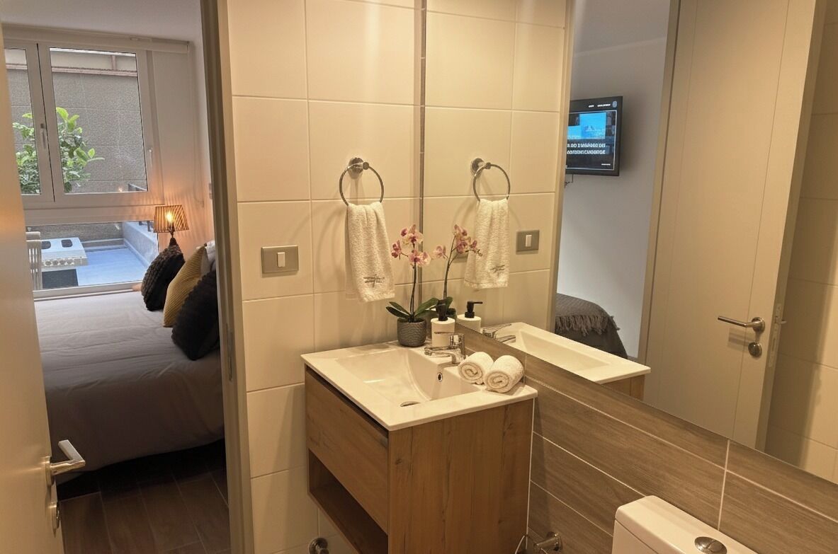 A modern bathroom with a wooden vanity, a double sink, and a large mirror.