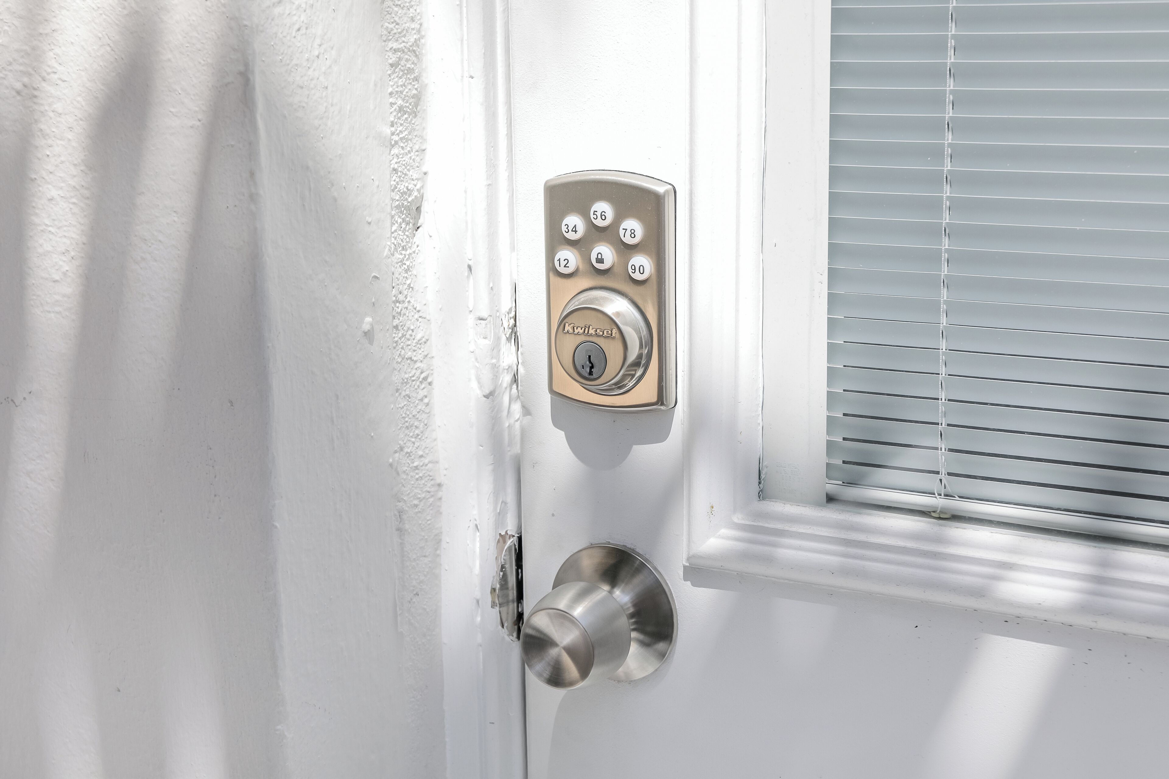 A door with a numeric keypad lock and a keyhole.
