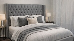 A bedroom with a tufted headboard, a large bed, two bedside tables with lamps, a ceiling fan, and a window with curtains. - Beautiful newly decorated 3-bedroom condo with 2 pools in Branson (Branson)