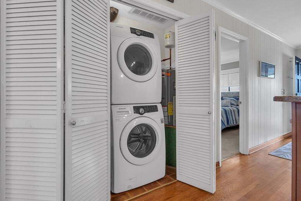 A laundry room with two stacked front-loading washing machines.