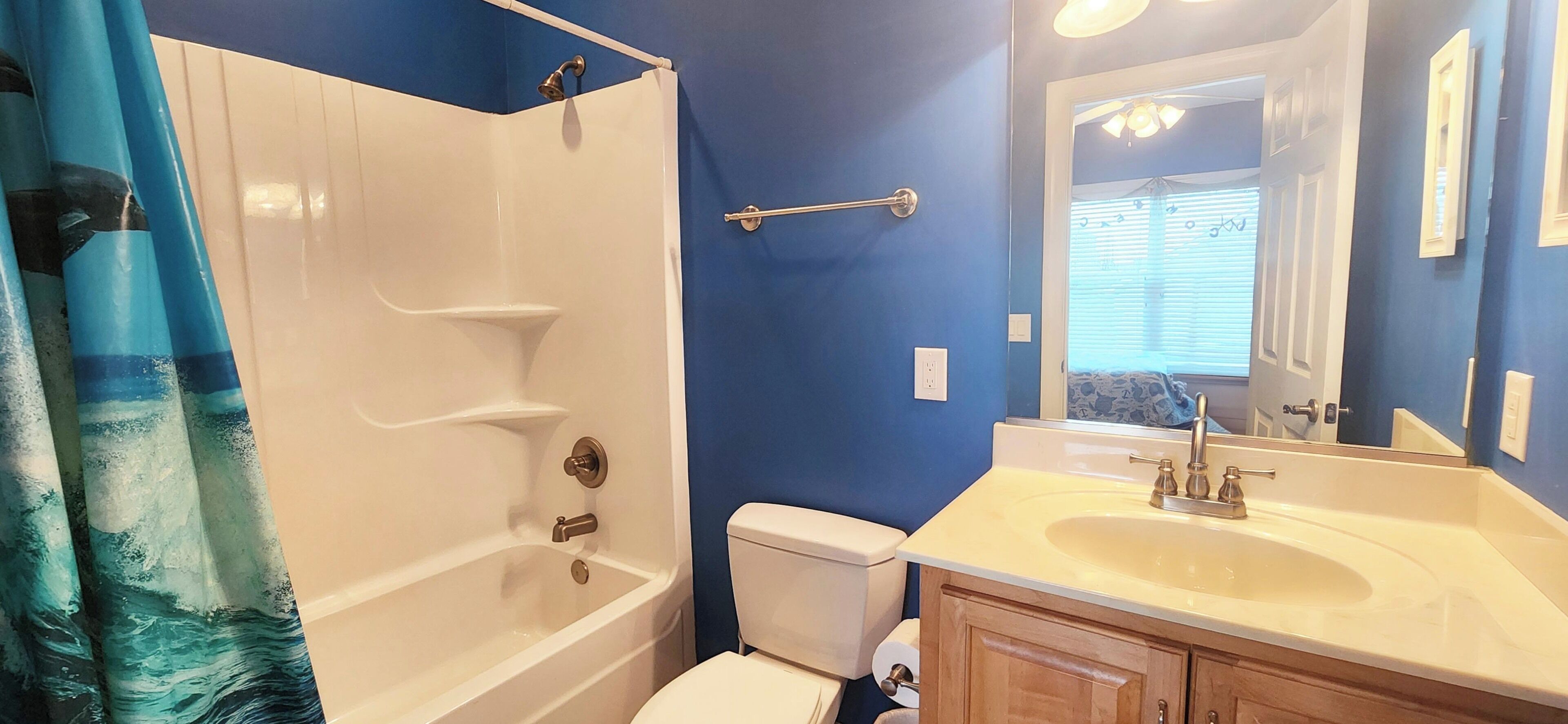 A bathroom with a bathtub, toilet, and sink.
