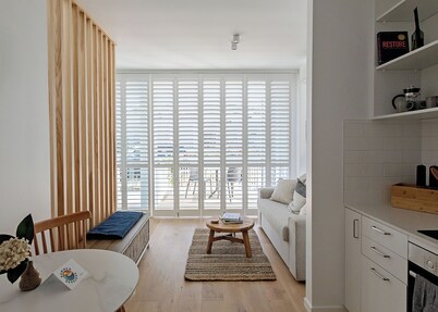 Stylish Sunny Matakana Townhouse Steps to Shops + Indoor-Outdoor Living.