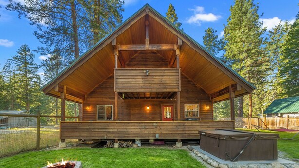 A wooden cabin with a fireplace, hot tub, and a covered deck. - Cozy cabin, dogs ok, hot tub, & fireplace (Leavenworth)