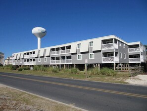 A multi-story hotel with a water tower labeled "Ocean Beach." - 3 br, 2 ba condo walking distance to beach (Ocean Isle Beach)