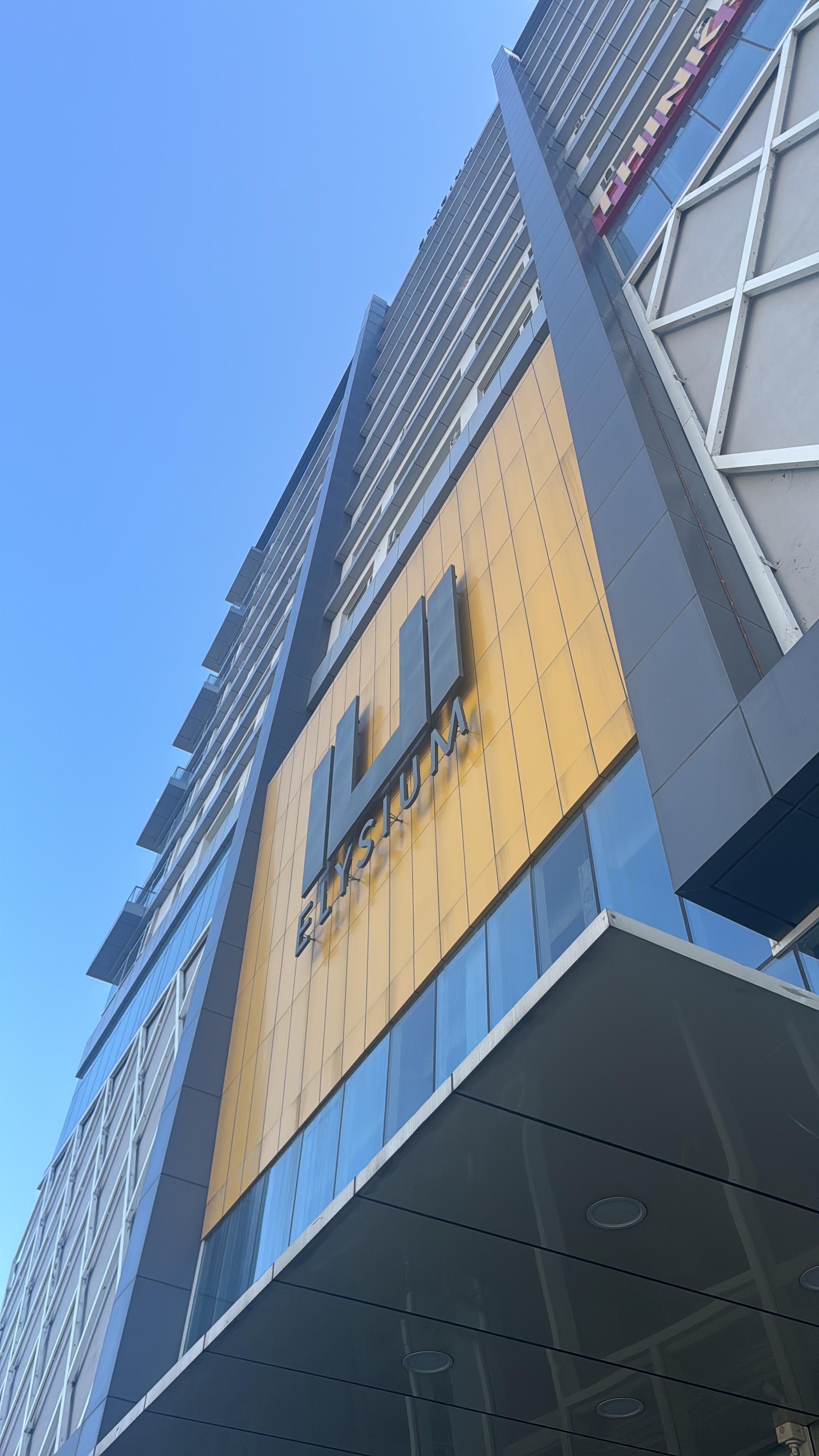 A modern building with a prominent sign reading 'Elysium.'