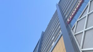 A modern building with a prominent sign reading 'Elysium.' - Charming 1-bedroom apartment with AC in vibrant Islamabad (Islamabad)