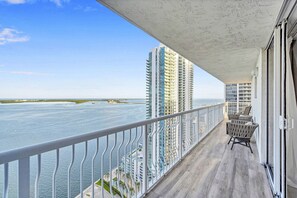 A balcony with a view of the ocean and tall buildings. - Luxurious private unit with parking (Miami)