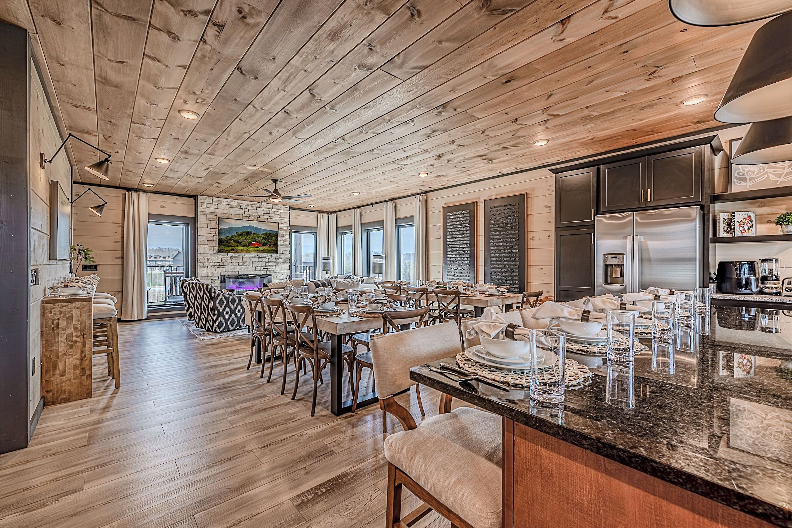 A spacious dining area with wooden floors and a large island counter.