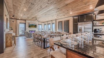 A spacious dining area with wooden floors and a large island counter.