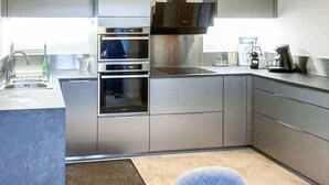 A modern kitchen with stainless steel appliances, a built-in oven, and a microwave. - 3 bedroom amazing home in Mutigney (Mutigney)