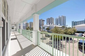 A balcony with a view of tall buildings and parked cars. - The Perdido Pearl (Pensacola)
